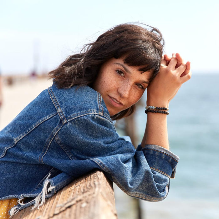 Woman wearing the The Cayman Bracelet by Edens Garden on a pier